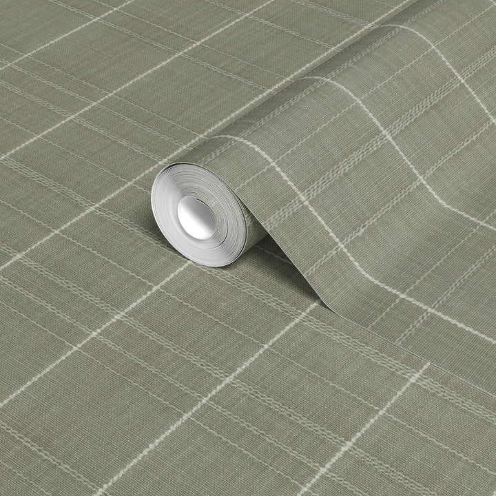 Varrone canvas wallpaper in sage gray with a textured woven finish and cream windowpane grid pattern, shown in a close-up of a rolled wallpaper sample.