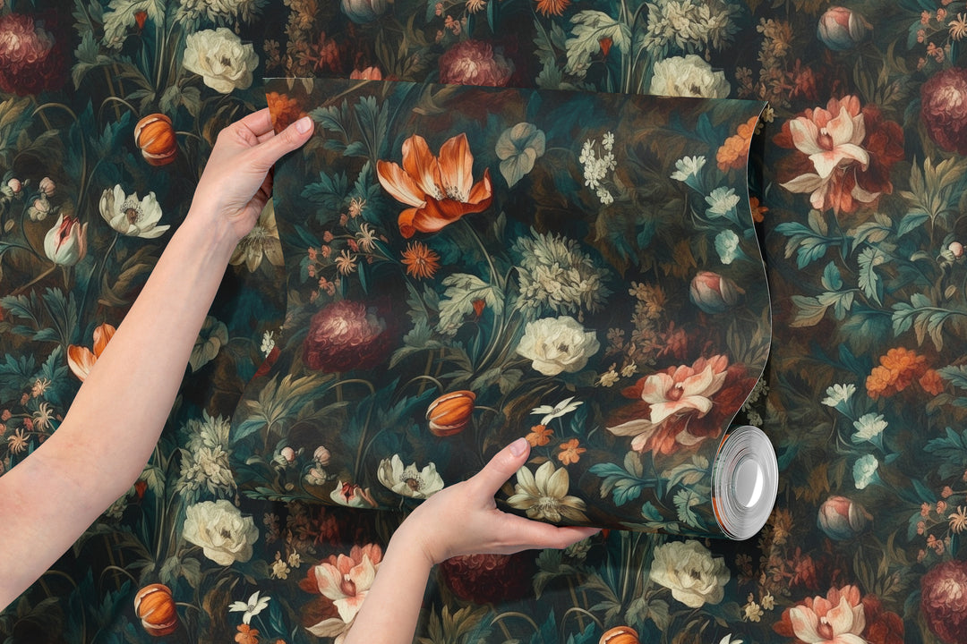 Orange and cream painterly botanical wallpaper shown in a hand-held rolled wallpaper sample.