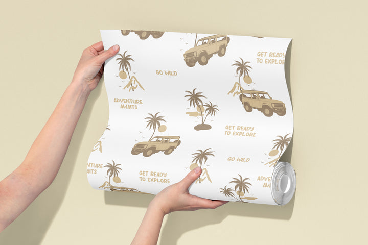 Roll of white safari jeep wallpaper with brown adventure illustrations, palm trees, and explorer design pattern