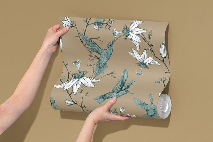 Roll of warm beige hummingbird wallpaper featuring a vintage botanical floral bird pattern.