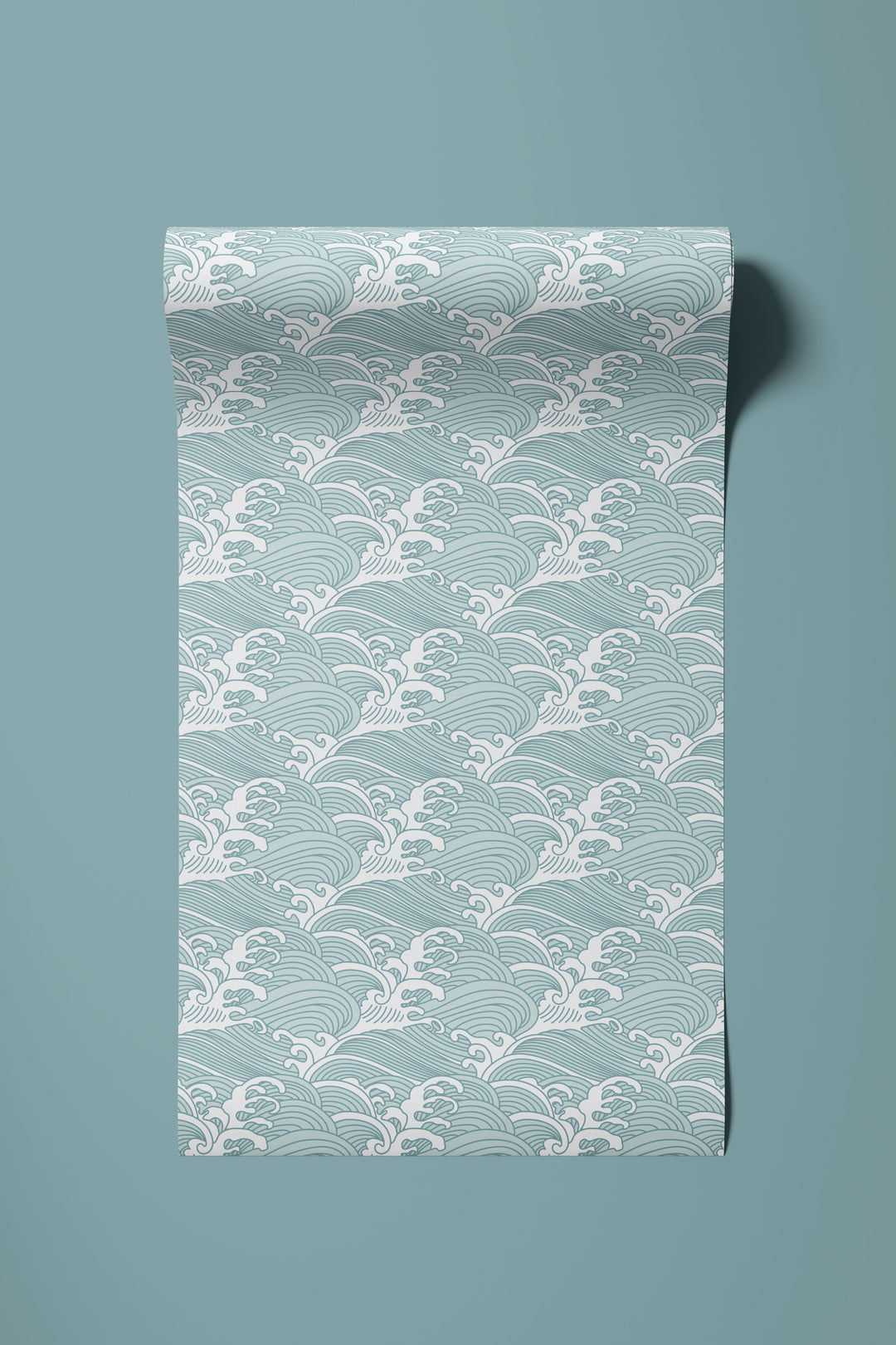 Roll of aqua blue Japanese wave wallpaper unrolled to show the traditional ocean pattern