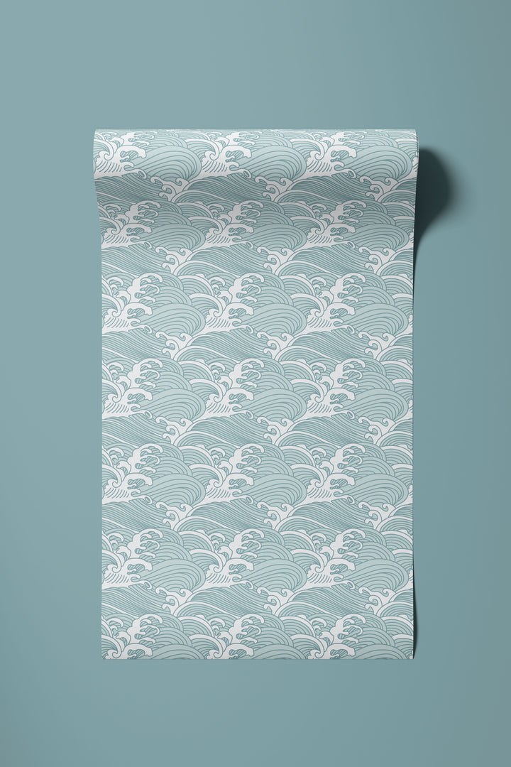 Roll of aqua blue Japanese wave wallpaper unrolled to show the traditional ocean pattern