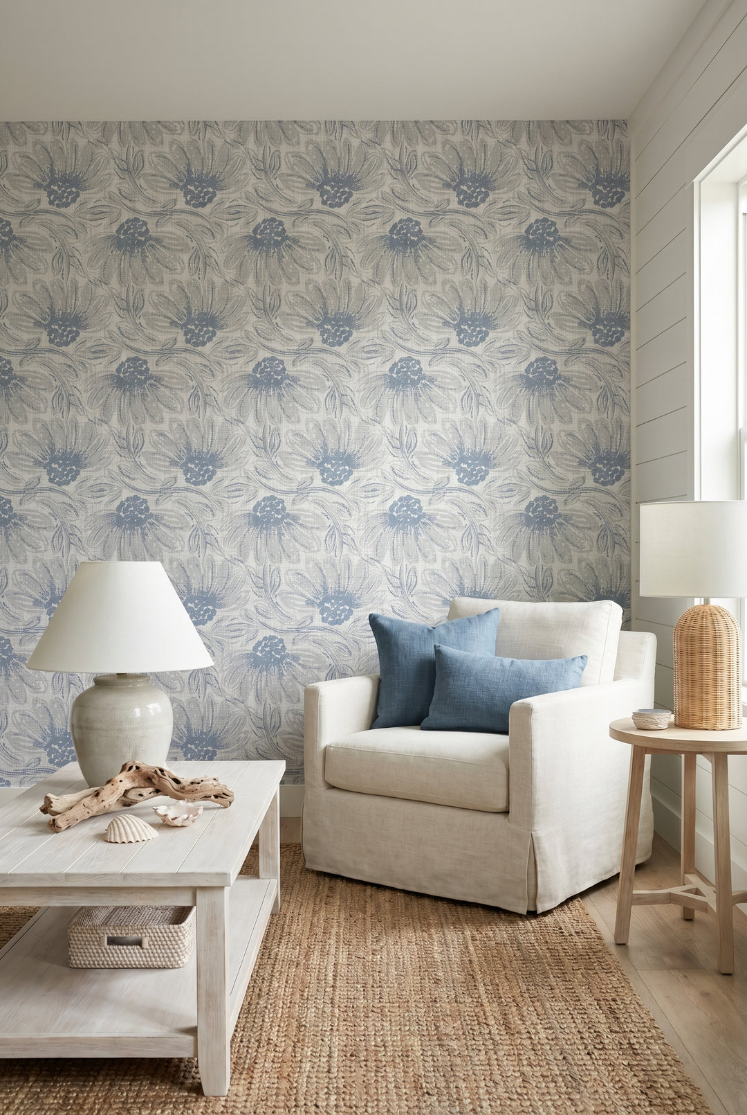 Living room with floral wallpaper, beige armchair, and decorative items.