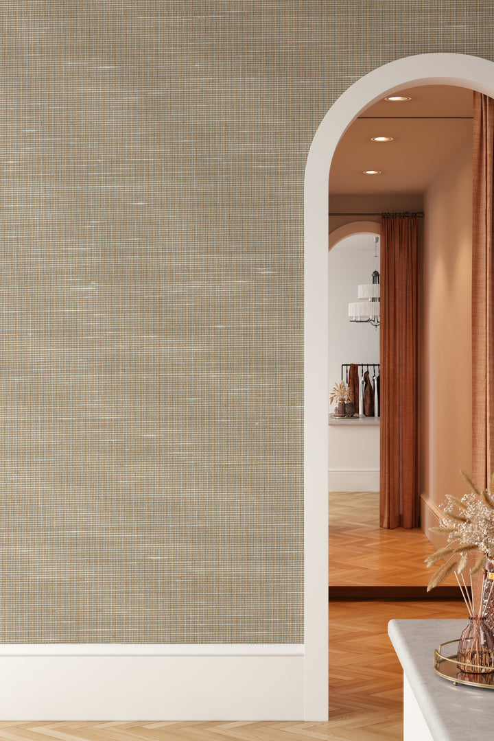 Wall with beige faux abaca grasscloth peel-and-stick wallpaper and arched doorway.