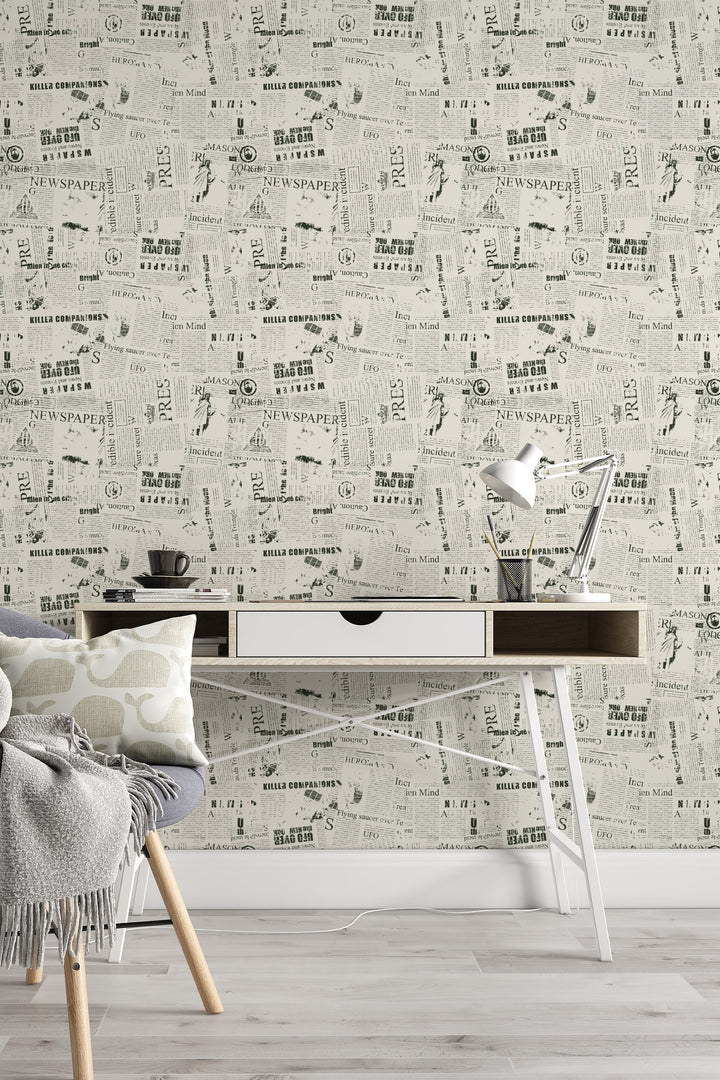 Home office with vintage newspaper collage wallpaper in black and white print and minimalist decor