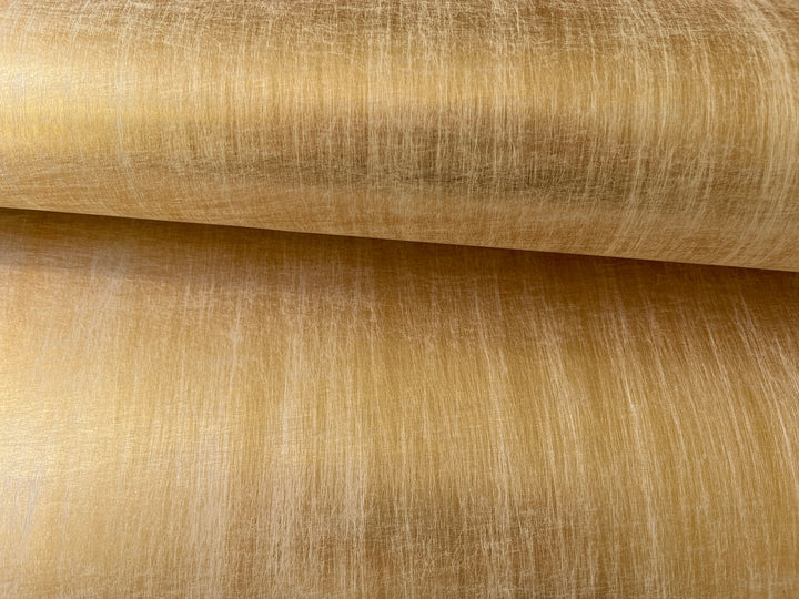 a close up of a gold colored fabric