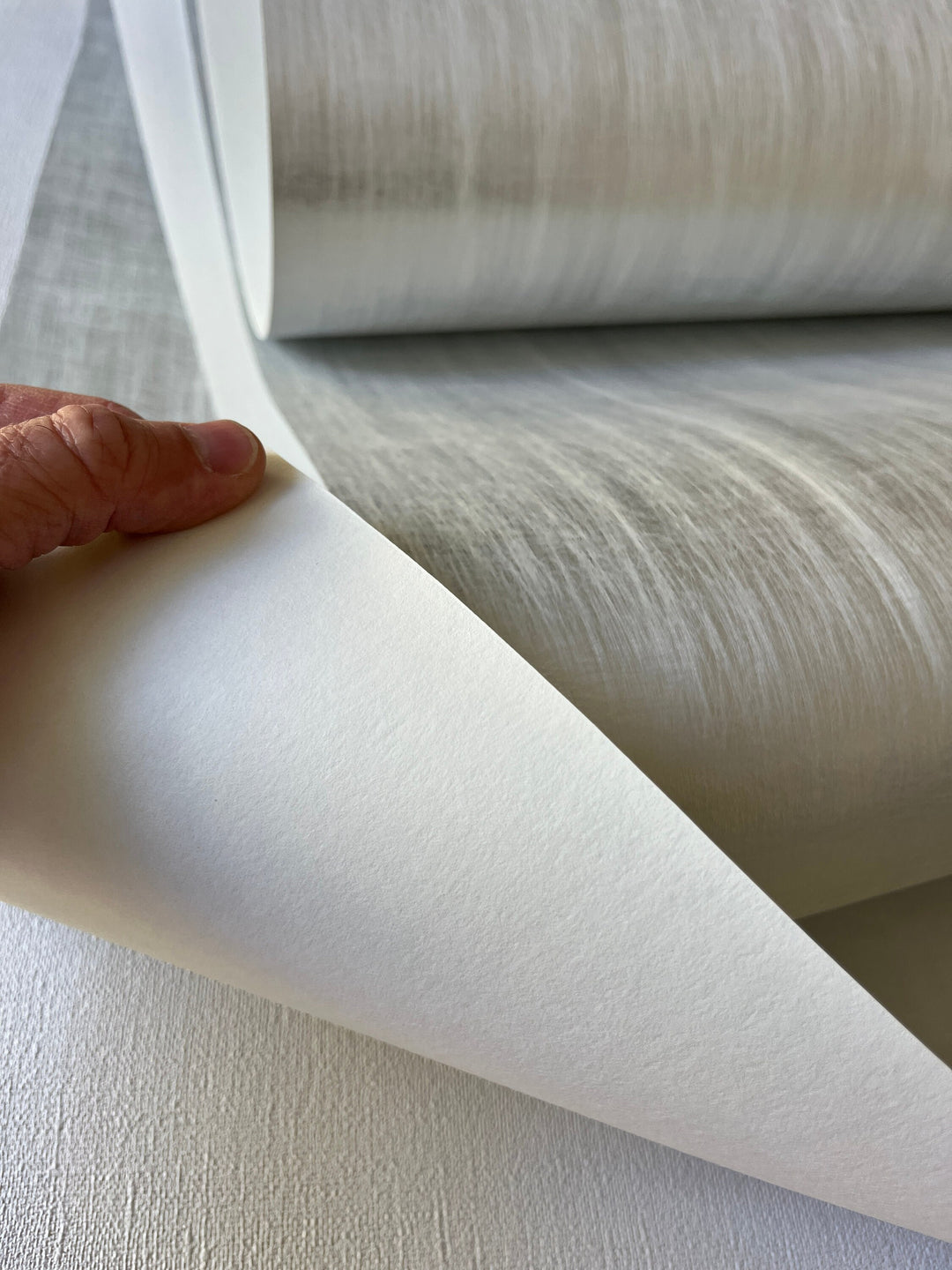 a person holding a roll of white paper